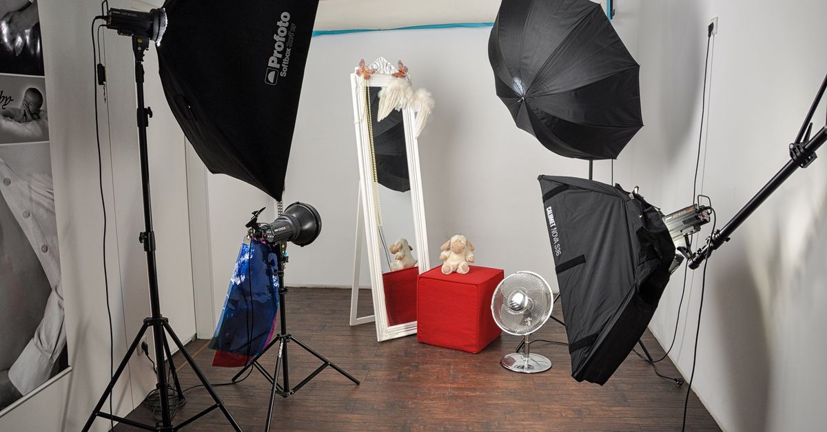Studio lighting setup with a softbox aimed at an empty backdrop
